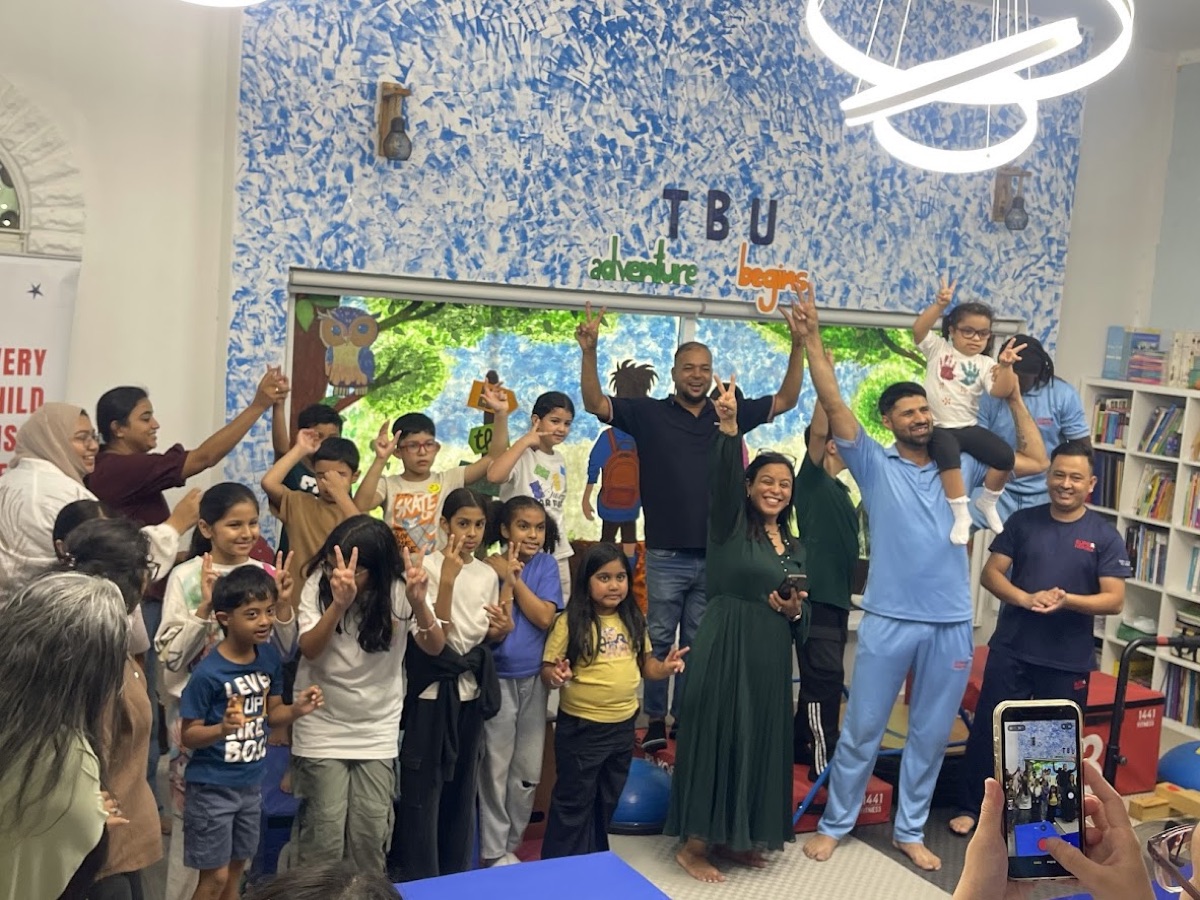 Vedhica with the children and volunteers at the Superheroes and Blue Umbrella event