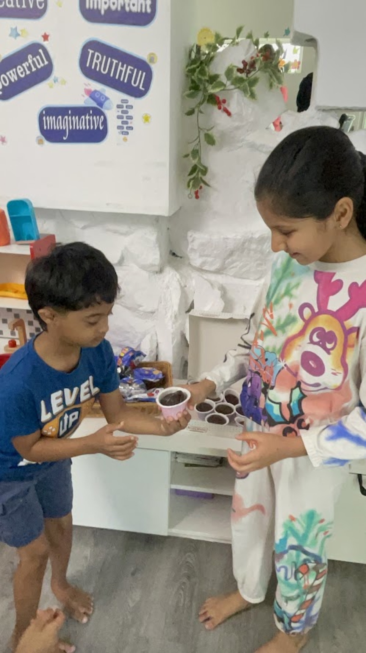 A child receiving a cupcake at the charity event