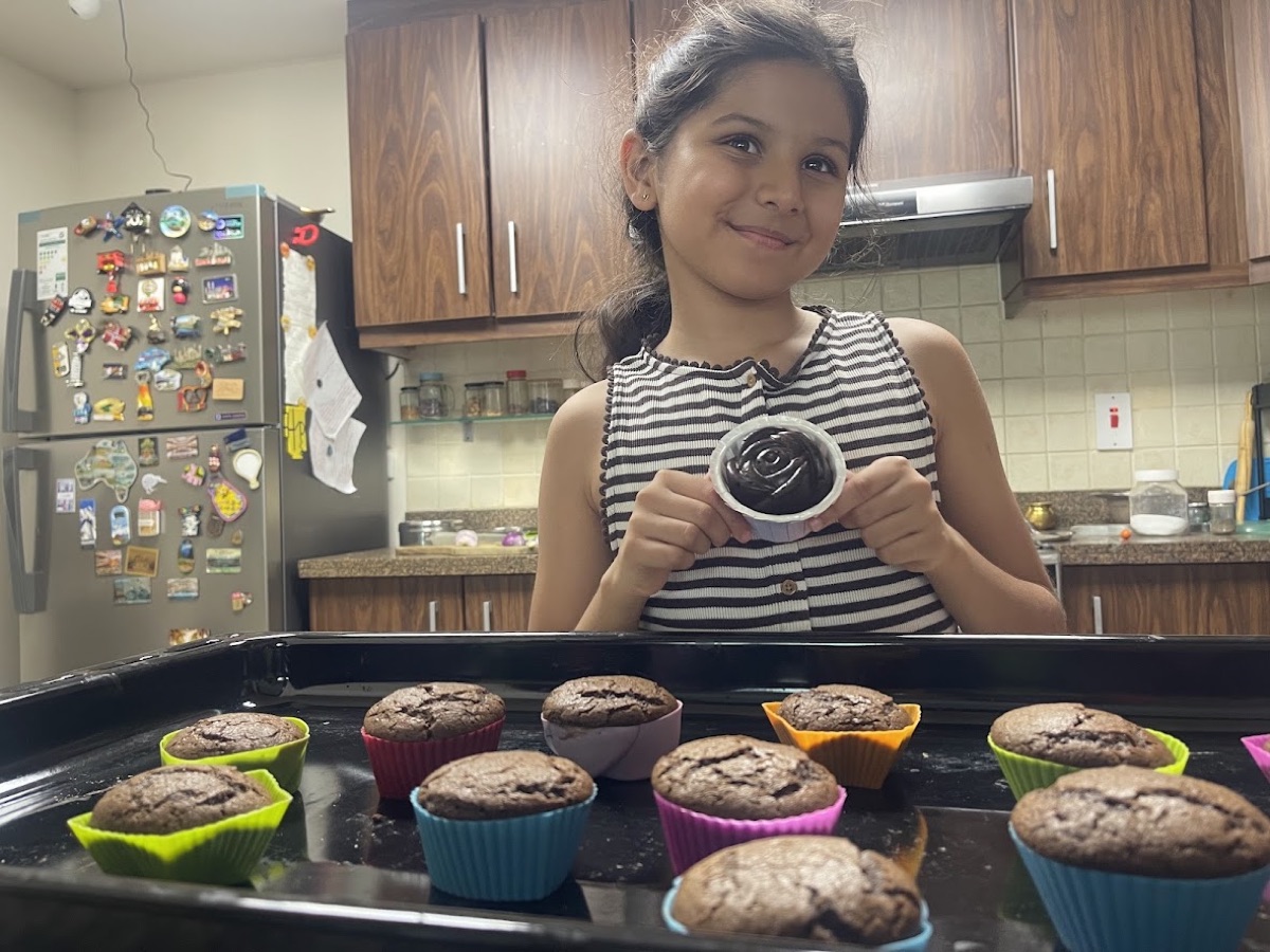 Vedhica holding a cupcake she baked